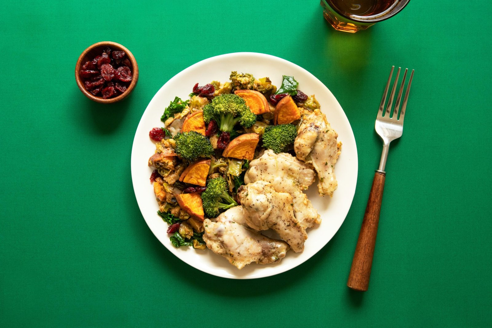 A plate of balanced healthy food featuring vegetables, quinoa, and fenugreek garnish.