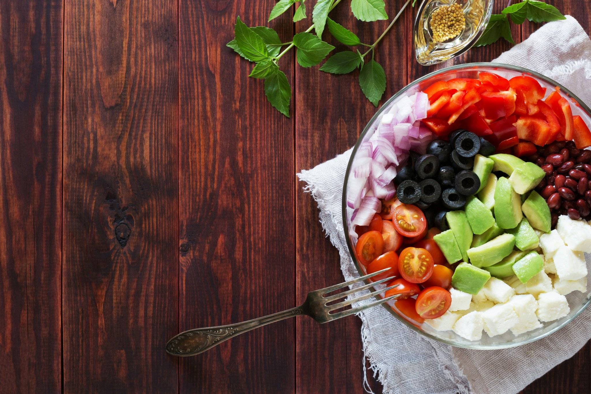 A bowl of fresh vegetables, grains, and herbs showcasing sattvic ingredients.