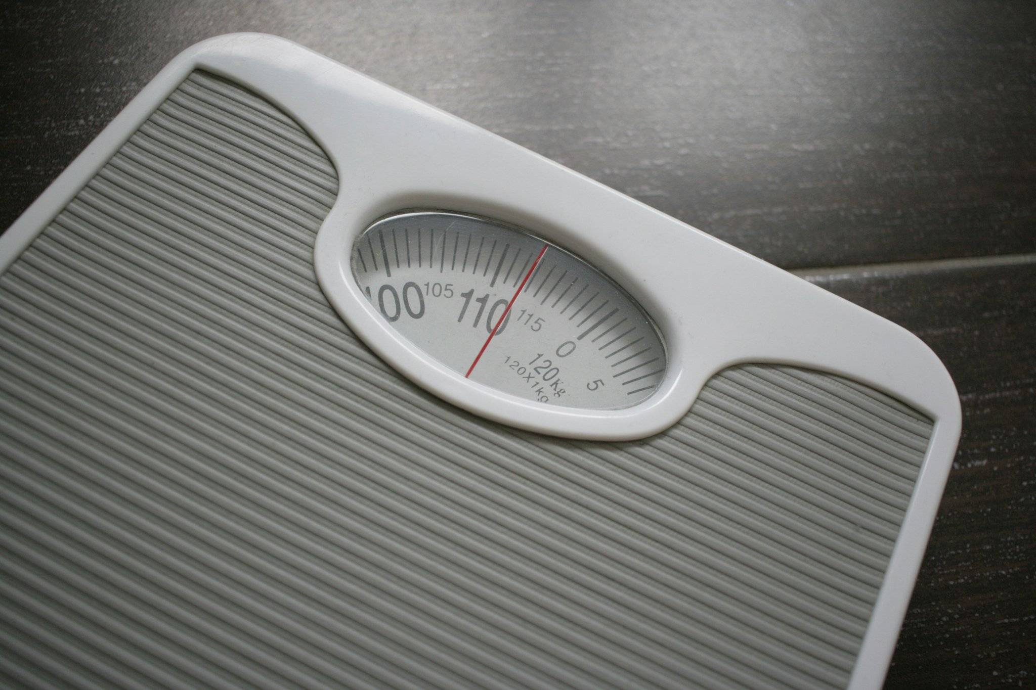 A stressed woman holding a scale
