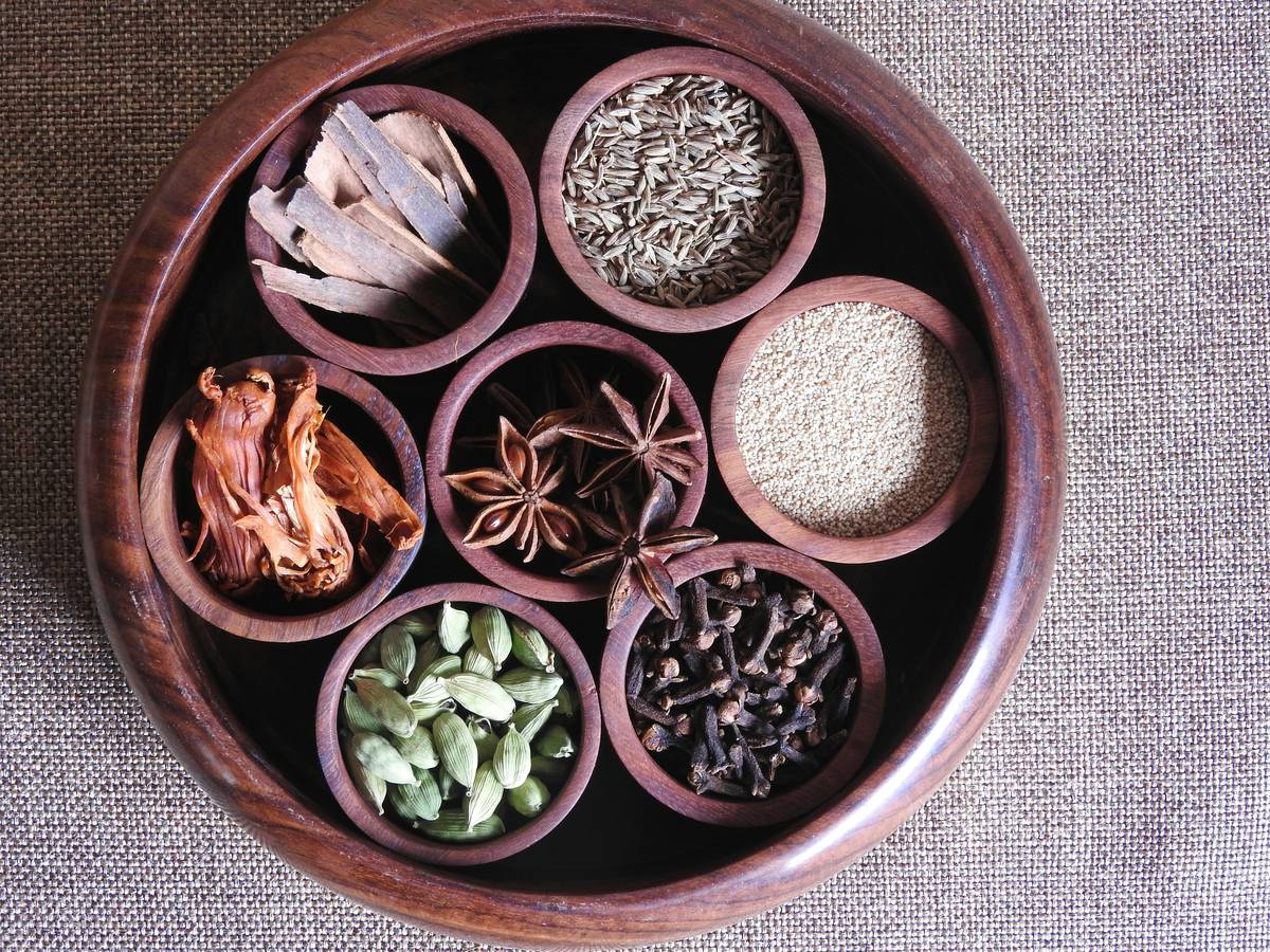 A woman organizing ingredients for Ayurvedic cooking.