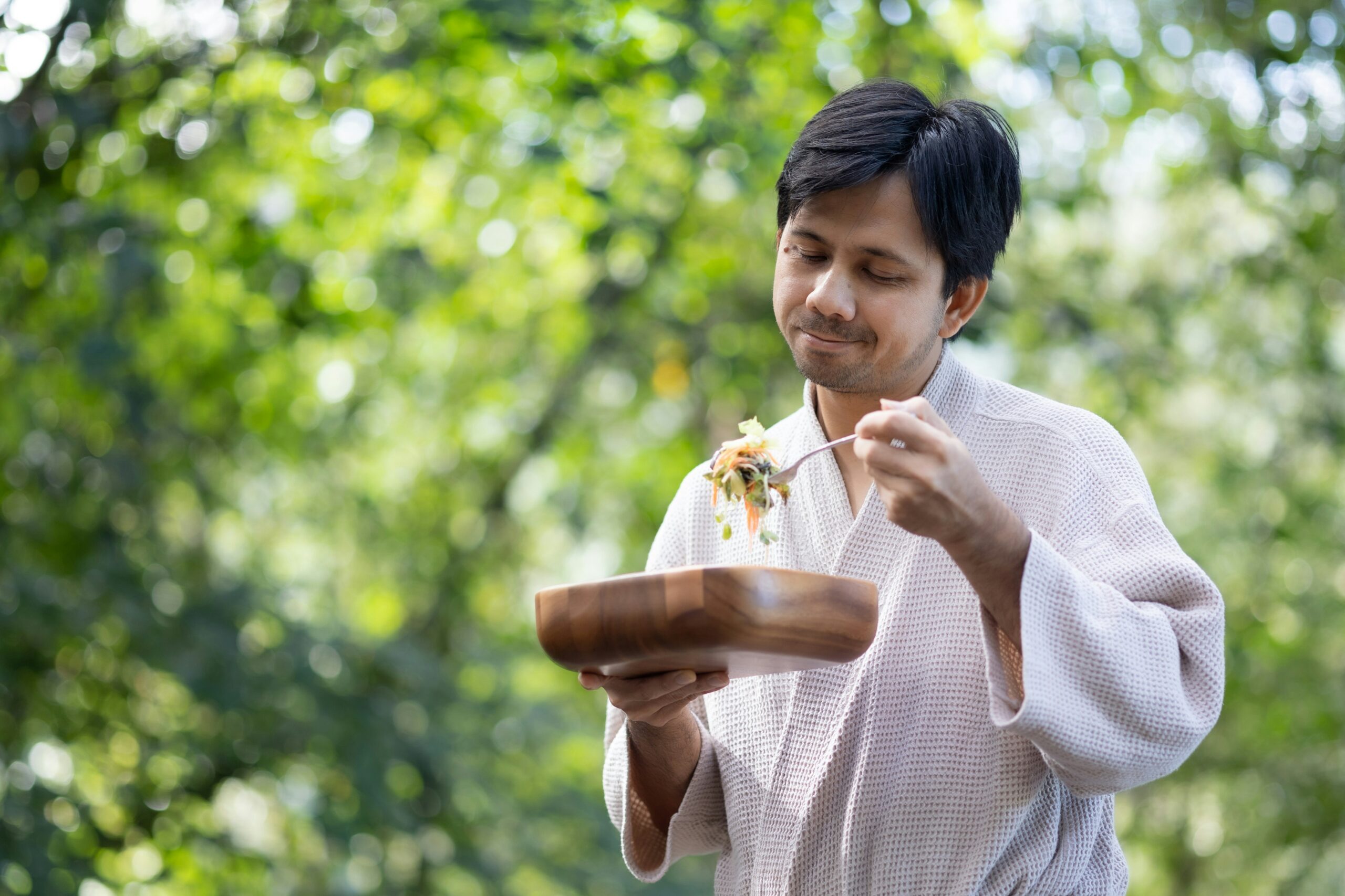 a man holding a plate of food in his hands