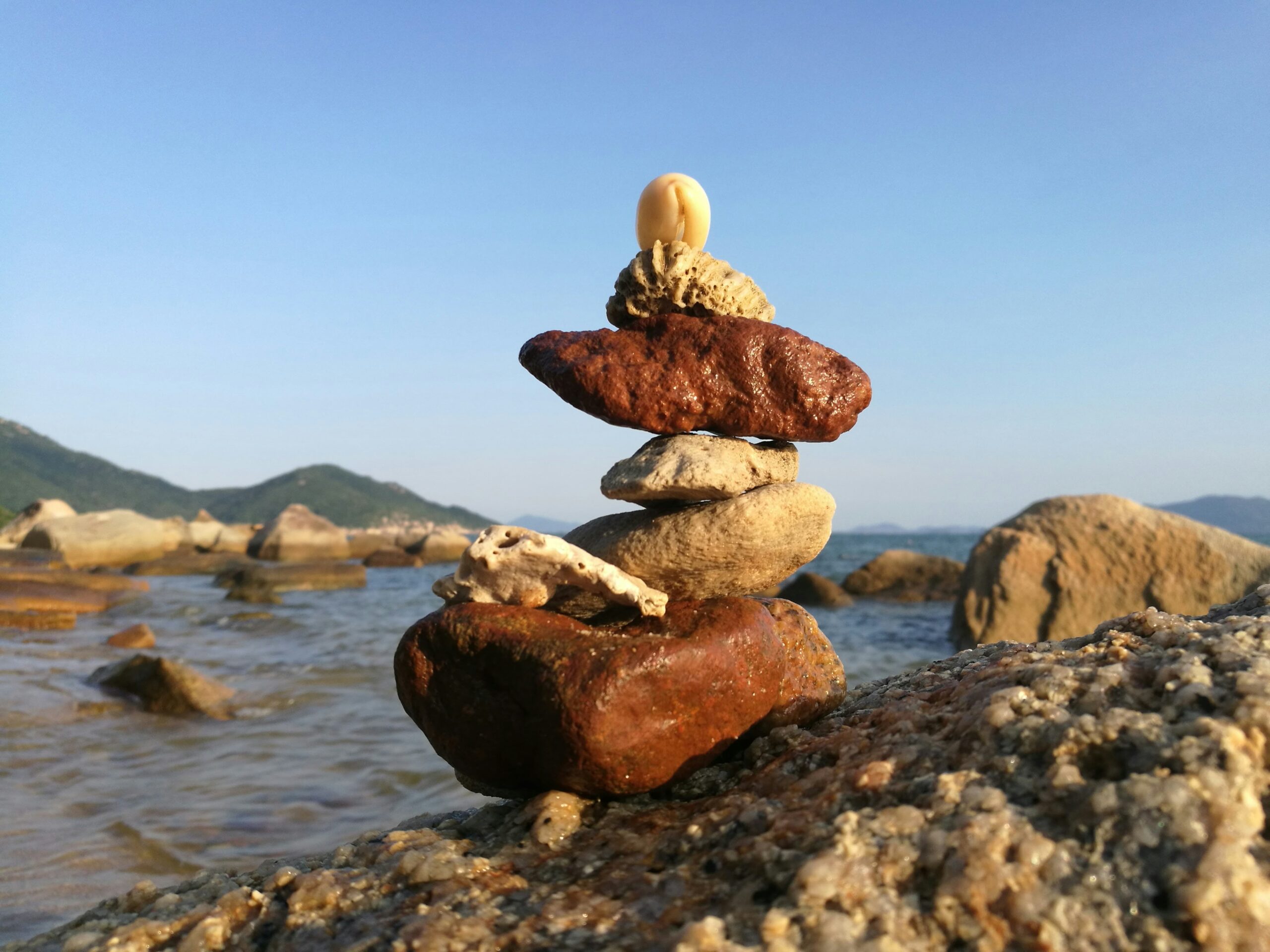 a stack of rocks sitting on top of a rocky beach